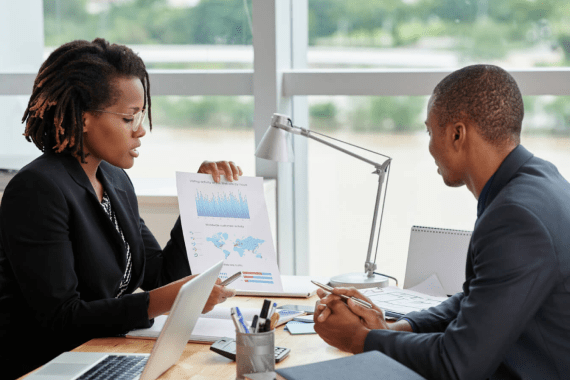 side-view-businesswoman-showing-analytical-charts-her-male-coworker